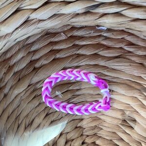 A homemade bracelet that is purple and wet